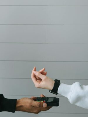 Close-up of a smartwatch being used for a contactless payment at a digital card terminal.